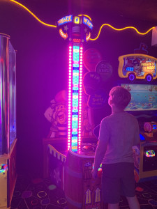 Boy playing "WHACK N' WIN" Arcade Game